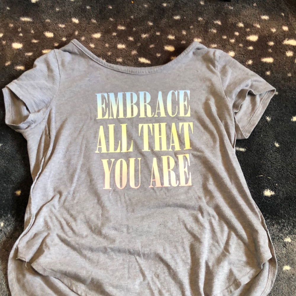 Gray tee with rainbow pastel writing that says “Embrace all that you are”